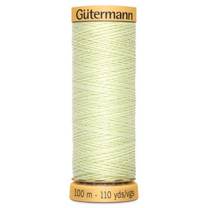 May include: A spool of pale green Gütermann thread. The spool has a yellow top with the Gütermann logo and a yellow base with the text "100 m - 110 yds/vgs". The thread is tightly wound around the spool.