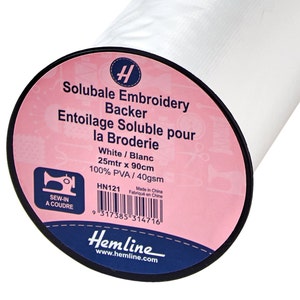 May include: White soluble embroidery stabilizer roll, 25 meters by 90 centimeters, 100% PVA, 40 grams per square meter. The label reads "Soluble Embroidery Backer Entoilage Soluble pour la Broderie White/Blanc 25mtr x 90cm 100% PVA/40gsm HN121 Made in China Fabriqué en Chine Sew-in a coudre Hemline www.hemline.com"
