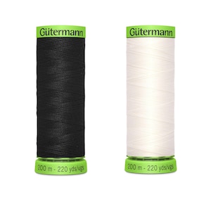 May include: Two spools of Gütermann sewing thread, one black and one white. Each spool has a green label with the brand name and the text "200 m - 220 yds/vgs". The spools are cylindrical.