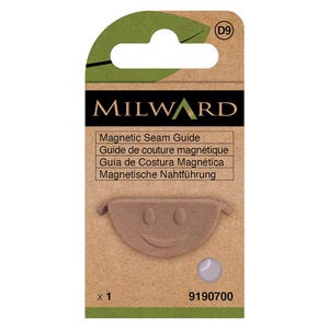 May include: A magnetic seam guide in a cardboard package. The guide is light brown and has a smiling face design. The package includes the text "MILWARD" and "Magnetic Seam Guide" in multiple languages. The product code is 9190700.