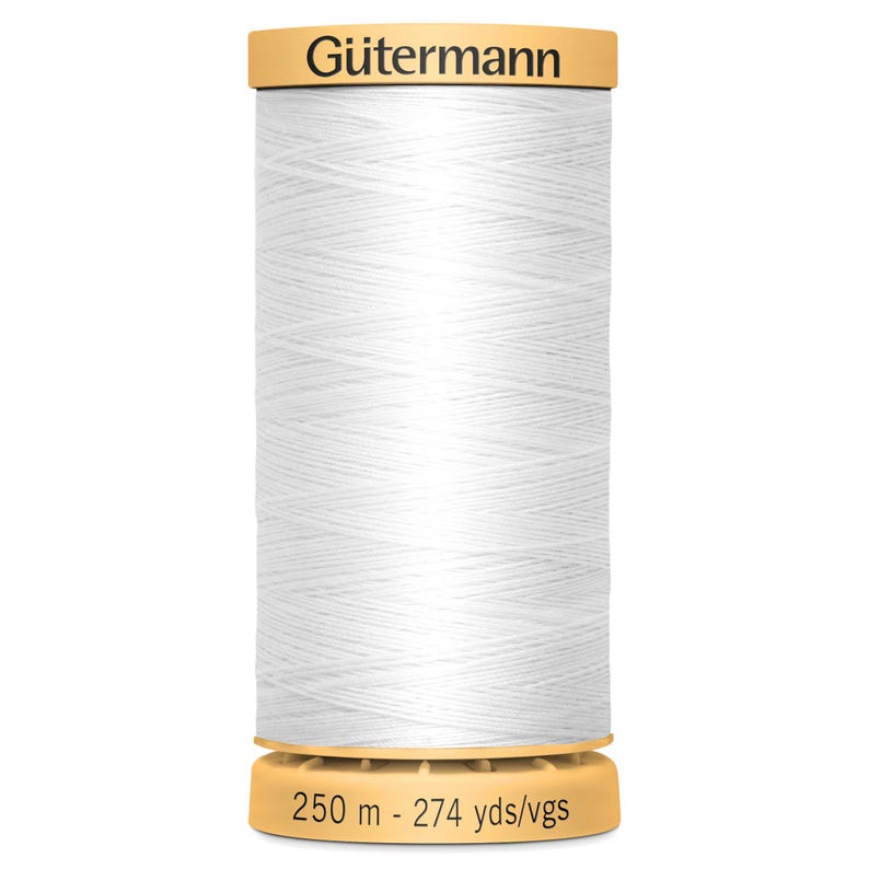 May include: A spool of white sewing thread by G&uuml;termann. The top of the spool features the brand name G&uuml;termann in black text. The bottom of the spool displays the length as 250 m - 274 yds/vgs. The thread is wound tightly around the cylindrical spool.