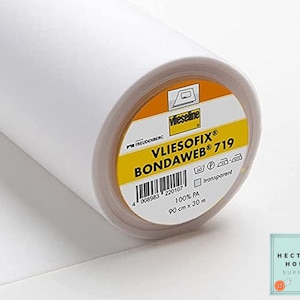 May include: A roll of white Vliesofix Bondaweb 719 fusible web, a transparent fabric adhesive for sewing and crafts. The label is yellow with black text and a barcode. The roll is 90 cm x 30 m.