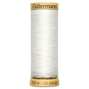 May include: A spool of white sewing thread by G&uuml;termann. The spool features a tan top label with the brand name and a tan base label displaying the length as 100 m - 110 yds/vgs. The white thread is wound in a cross-hatch pattern around the cylinder.