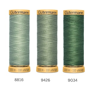 May include: Three spools of Gütermann thread in shades of green. The spools are labelled with the numbers 8816, 9426, and 9034. Each spool contains 100 metres of thread. The thread is wound on a cylindrical spool with a gold label.