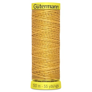 May include: A golden yellow spool of Gütermann thread. The thread is tightly wound. The spool has a yellow base with the text "50 m - 55 yds/vgs". The top of the spool has the Gütermann logo. The thread measures approximately 45.7 meters.