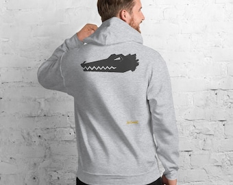 May include: A light gray hooded sweatshirt featuring a dark gray graphic of a stylized crocodile head on the back. The design includes a small yellow text element that reads No Comment positioned below the crocodile graphic on the back.
