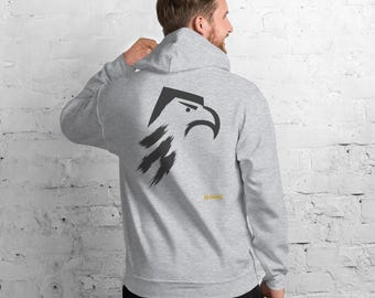 May include: A light gray hooded sweatshirt featuring a dark gray graphic of an eagle head on the back. The eagle design has a sharp, angular beak and eye with brushstroke-style feathers below. The text "No Comment" is printed in small yellow letters.