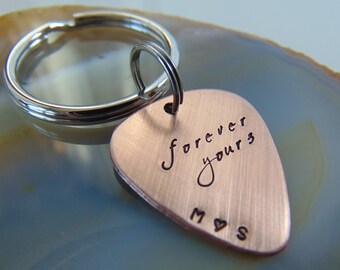 May include: Copper guitar pick keychain with the words "forever yours" and the initials "M & S" engraved on it.