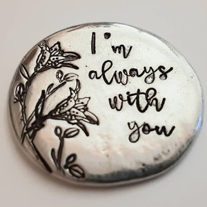 May include: A silver charm with a floral design and the text "I'm always with you".