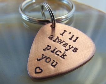 May include: A copper guitar pick keychain with the text "I'll always pick you" and a small heart engraved on the front.