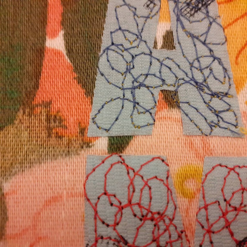 Applique embroidery textile art ready to frame. What about me