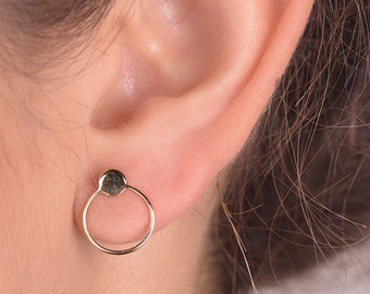 May include: Gold circle earrings with a small round accent at the top.