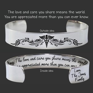 May include: A silver cuff bracelet with a black medical symbol and floral design. The outside of the bracelet has the text "The love and care you share means the world. You are appreciated more than you can ever know."