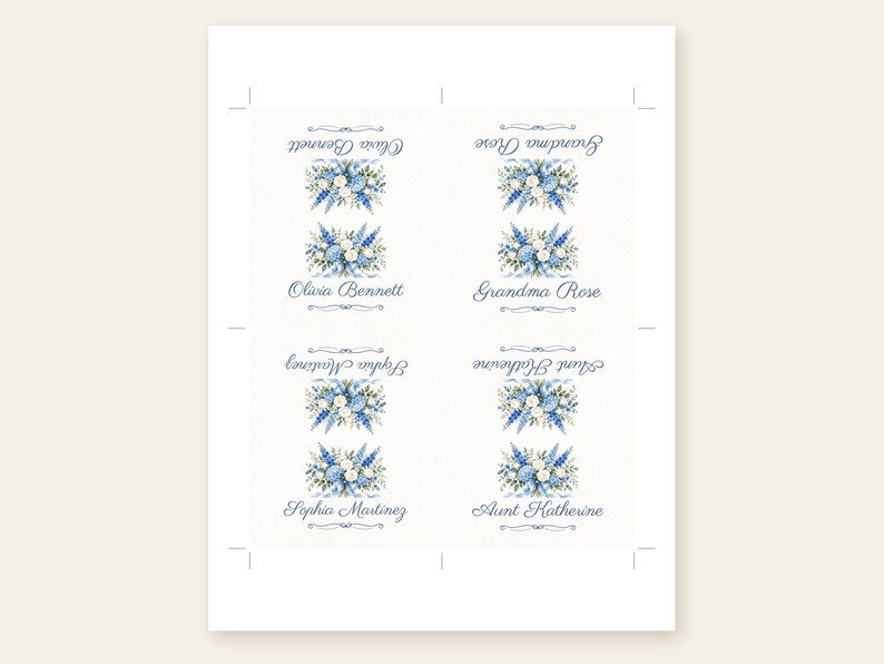 Puede incluir: Una hoja con cuatro tarjetas de sitio rectangulares que presentan un arreglo floral en acuarela de flores azules y blancas con hojas verdes. Cada tarjeta muestra un nombre en letra cursiva azul: Olivia Bennett, Grandma Rose, Sophia Martinez y Aunt Katherine.