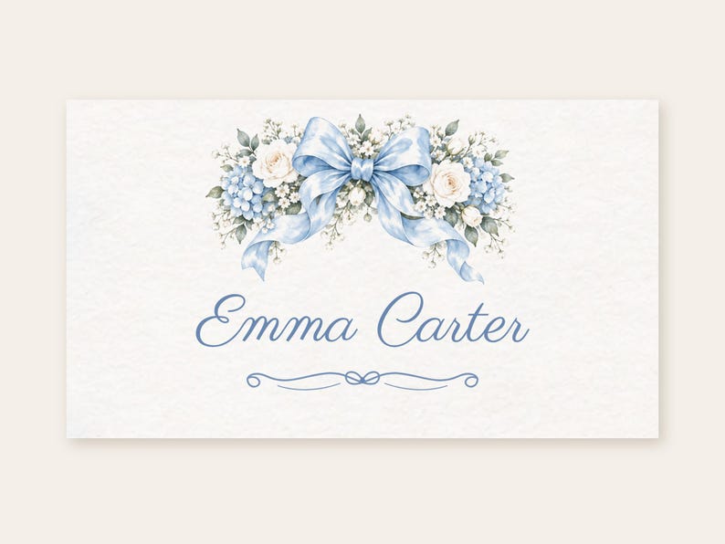 May include: A rectangular card featuring a watercolor illustration of a light blue ribbon bow centered above a floral arrangement of white roses and blue hydrangeas. The name Emma Carter is printed in blue script below the flowers.