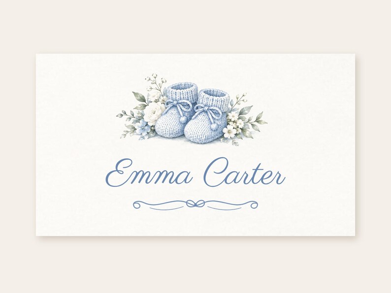 May include: A rectangular card featuring a watercolor illustration of a pair of light blue knitted baby booties surrounded by white and blue flowers and green leaves. The name Emma Carter is printed in blue script below the booties.
