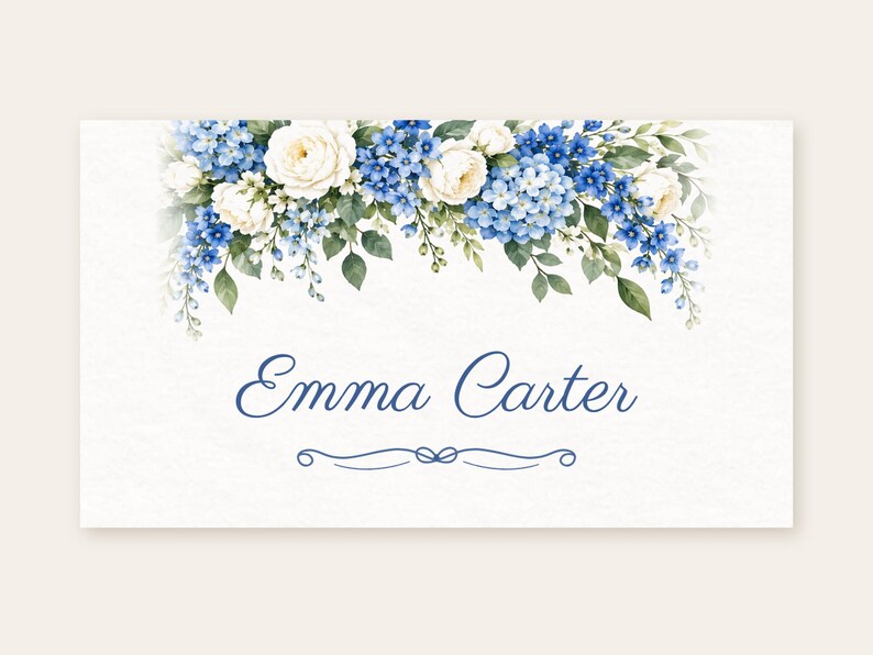 May include: A rectangular white card featuring a watercolour floral arrangement of blue hydrangeas, white roses, and green leaves along the top edge. The name Emma Carter is printed in blue script in the centre, with a decorative blue flourish below.