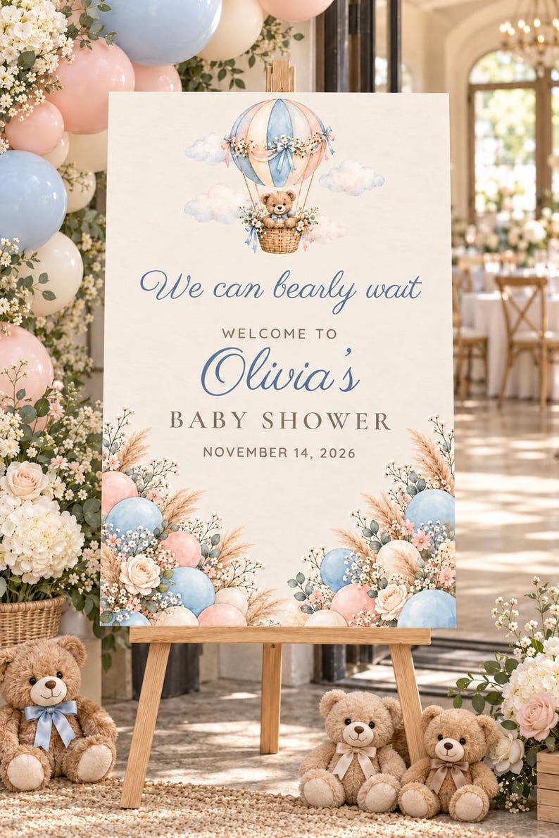 Puede incluir: Un letrero de bienvenida rectangular para un baby shower con una ilustraci&oacute;n en acuarela de un oso de peluche en un globo aerost&aacute;tico, globos azules y rosas y detalles florales. El texto dice: We can bearly wait, Welcome to Olivia's Baby Shower, November 14, 2026.