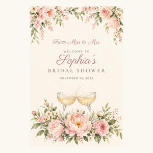 May include: A rectangular sign featuring watercolor pink peonies and green foliage at the top and bottom. The text reads: From Miss to Mrs. WELCOME TO Sophia's BRIDAL SHOWER NOVEMBER 14, 2026. Two champagne glasses clinking are centered above the flowers.