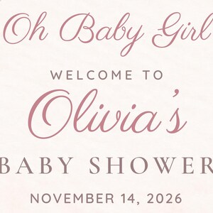 May include: A pale pink sign featuring dark pink text that reads: Oh Baby Girl WELCOME TO Olivia's BABY SHOWER NOVEMBER 14, 2026. The design uses a combination of elegant cursive script and clean, capitalized sans-serif typography.