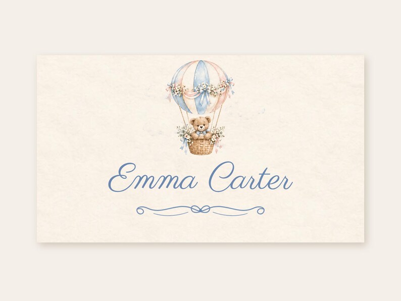May include: A rectangular card featuring a watercolour illustration of a teddy bear in a blue and beige hot air balloon decorated with flowers. Below the illustration, the name Emma Carter is printed in blue script, followed by a decorative line.