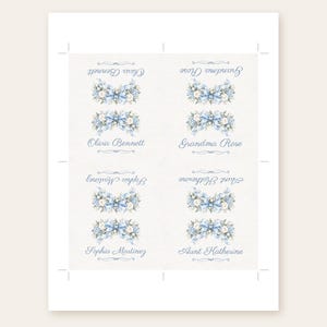 May include: A sheet of four rectangular paper labels featuring a blue floral bouquet illustration with a central bow. Each label displays a name in blue script: Olivia Bennett, Grandma Rose, Sophia Martinez, and Aunt Katherine, with some text inverted.