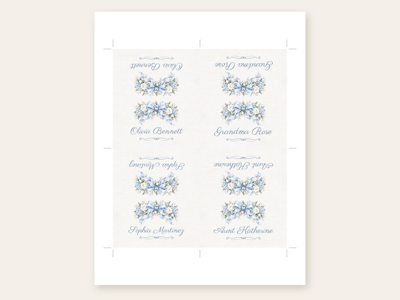May include: A sheet of four rectangular paper labels featuring a blue floral bouquet illustration with a central bow. Each label displays a name in blue script: Olivia Bennett, Grandma Rose, Sophia Martinez, and Aunt Katherine, with some text inverted.