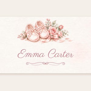 May include: A rectangular card featuring a watercolor illustration of a pair of light pink baby shoes, a bouquet of pink roses, and a ribbon. The text Emma Carter is printed in a dark pink script font below the illustration.