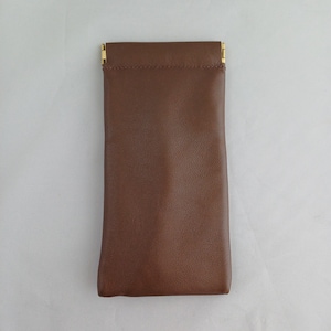 May include: A brown leather glasses case with gold metal clasps.