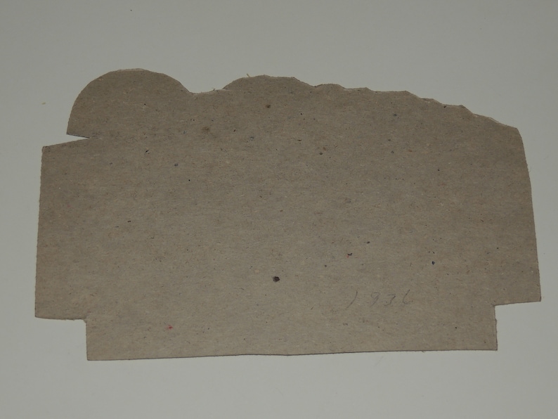 May include: A brown cardboard tag with the number "1936" handwritten on it.