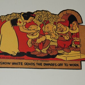 May include: Snow White, dressed in a yellow dress and red cape, is saying goodbye to the seven dwarfs. The dwarfs are wearing brown pants and shirts, and red hats. The dwarfs are standing on a platform, and Snow White is standing on the ground. The text on the image reads "1938 WALT DISNEY ENTERPRISES", "FOLD FORWARD", "SNOW WHITE SENDS THE DWARFS OFF TO WORK", and "FOLD BACK".