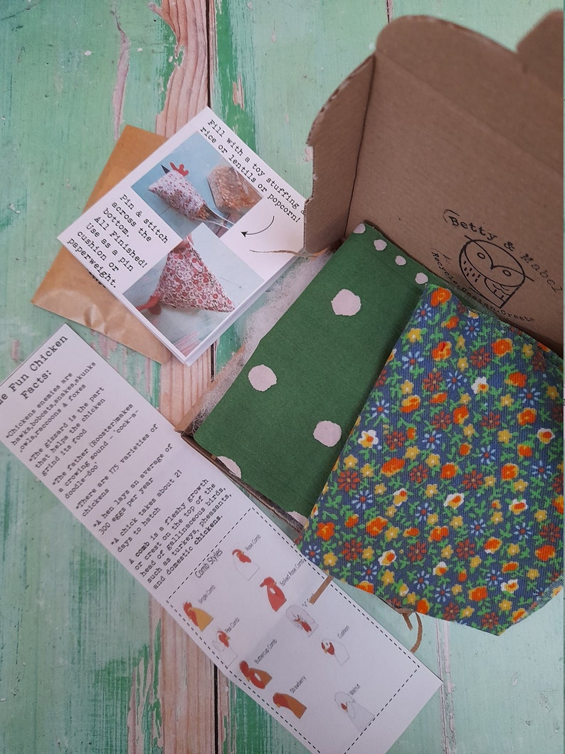 Puede incluir: Una tela verde y blanca con lunares blancos y una tela floral azul y naranja. Las telas est&aacute;n en una caja de cart&oacute;n con una nota que dice "&iexcl;Rellena con un relleno de juguete: arroz o lentejas o palomitas!" y "Datos divertidos sobre las gallinas: Los enemigos de las gallinas son los halcones, los linces, las serpientes, las mofetas, los b&uacute;hos, los mapaches y los zorros. La molleja es la parte que ayuda a la gallina a moler su comida. El padre (gallo) hace un sonido de canto de gallo, cock-a-doodle-doo. Hay 175 variedades de gallinas. Una gallina pone un promedio de 300 huevos por a&ntilde;o. Un pollito tarda unos 21 d&iacute;as en eclosionar. Una cresta es un crecimiento carnoso o una cresta en la parte superior de la cabeza de las aves galliformes, como los pavos, los faisanes y las gallinas dom&eacute;sticas. Estilos de cresta: Cresta simple, Cresta de rosa, Cresta en V, Cresta de bot&oacute;n de oro, Cresta de fresa y Cresta de gorri&oacute;n."