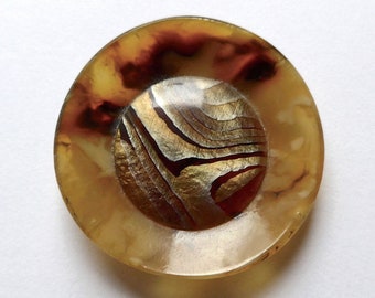 Celluloid button, antique/vintage.  Concave with a convex centre, intermixed yellows/gold centre, metal loop shank, c1920s-30s.