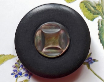 Pearl centre button, vintage.  Black resin with a circular centre of cut abalone shell, metal loop shank.  c1910's - 20's.