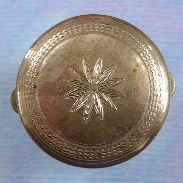 Batchelors button, antique.  Circular with a floral based central design, no maker, brass.  c1870's-80's.