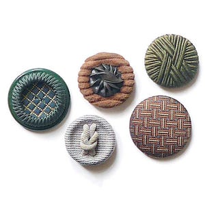 May include: Five assorted vintage buttons in different styles and colours. The buttons feature a green button with a diamond pattern, a brown button with a leaf design, and a button with a woven pattern.