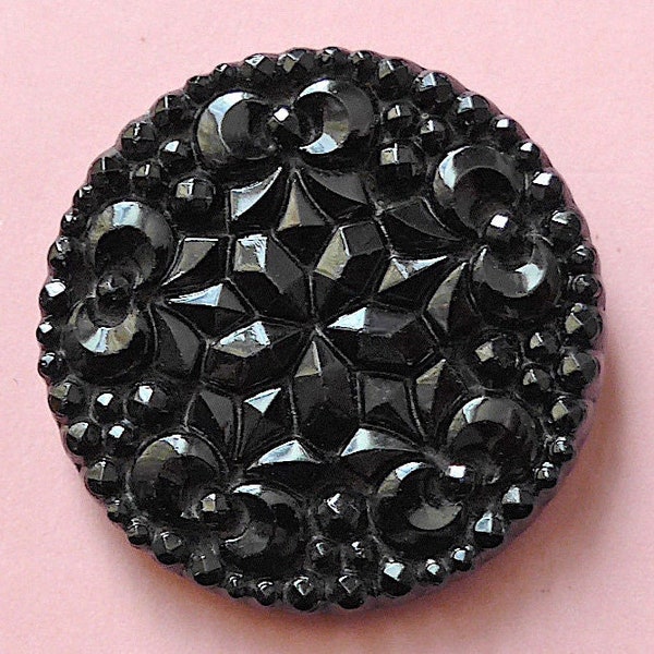 Black glass button, antique.  Circular pressed glass with a pretty design, metal loop shank. c19th century-early 20th.