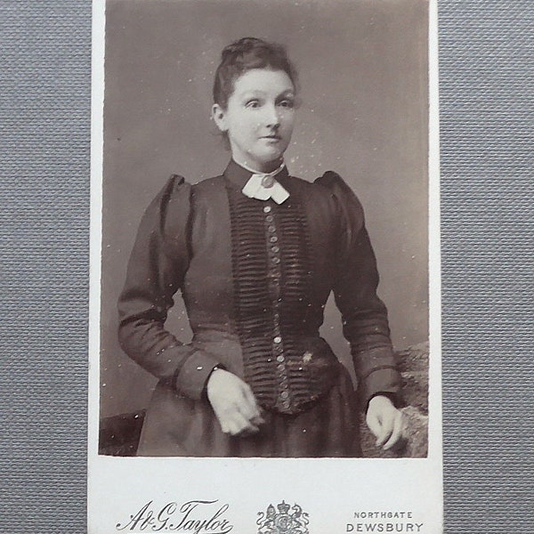 Carte-de-visite, sepia, antique.  A lady with a pensive smile & numerous buttons.  A.G. Taylor, Northgate, Dewsbury, W. Yorks. c1880's.