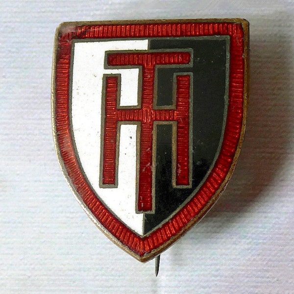 Harvester Tractors badge, vintage. Featuring the initials HT, shield shaped, champleve enamel, red, white & black. Thos. Fattorini. c1950's.