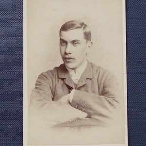Carte-de-Visite, sepia, antique. A portrait of a serious handsome young man.  J.E. Bliss late Arthur Nicholls, Cambridge. c1880's.