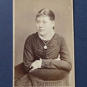 Carte-de-visite, sepia, antique.  Featuring a poised young lady.  Photographer, E. Smorthwaite, 174 Regent St. W. London. c1890.
