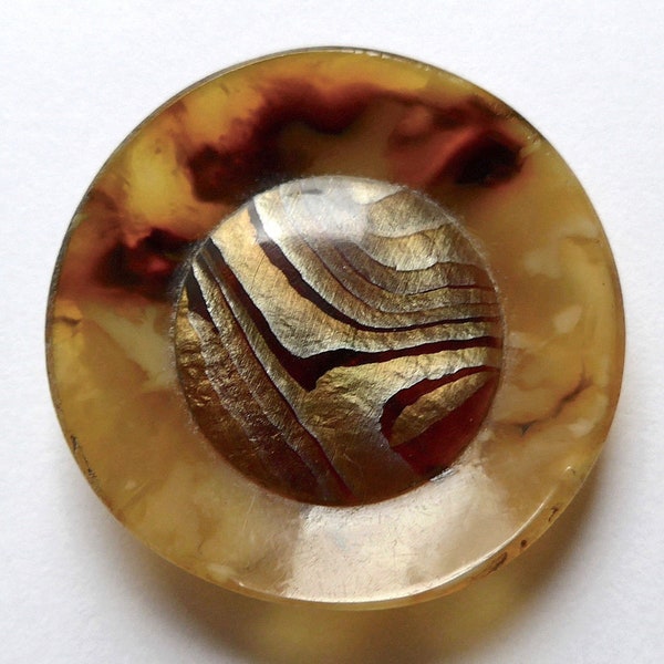 Celluloid button, antique/vintage.  Concave with a convex centre, intermixed yellows/gold centre, metal loop shank, c1920s-30s.