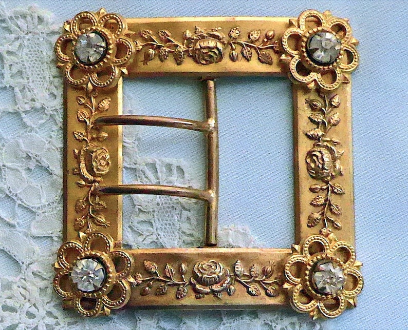 antique Buckle c1900. with floral claw set diamante escutcheon corners Square pressed metal a design of roses 2 prong chape lovely