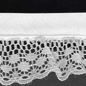 May include: White lace trim with a delicate floral pattern. The lace has a scalloped edge and is approximately 1 inch wide.