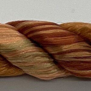 May include: A strand of brown and beige twisted rope beads. The beads have a marbled pattern and are strung together in a continuous loop.