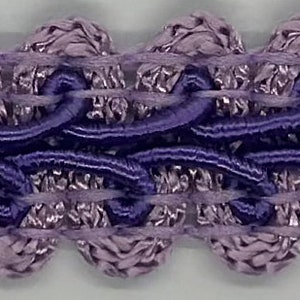 May include: Purple and light purple trim with a decorative design. The trim is made of a soft, woven fabric.
