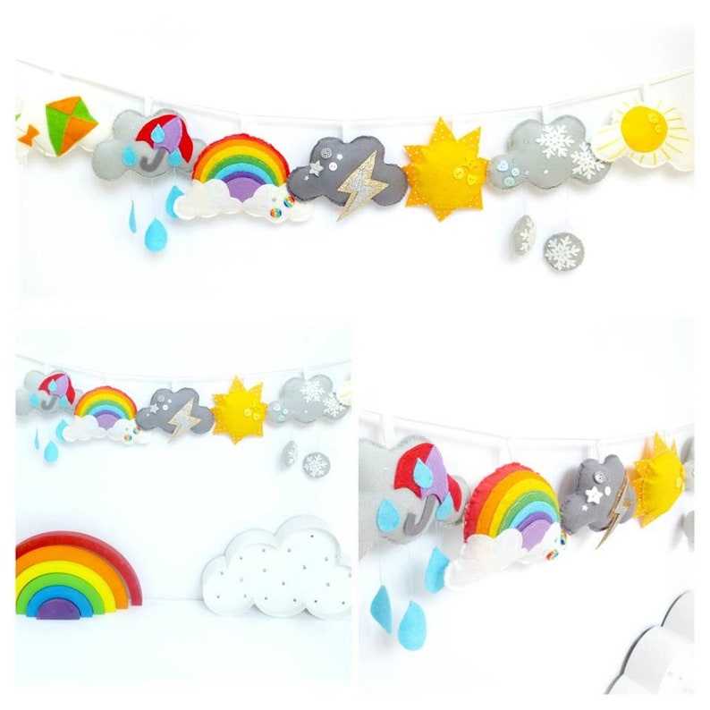 K&ouml;nnte beinhalten: Eine Filz-Wettergirlande mit Wolken, einem Regenbogen, einer Sonne, einem Blitz, einer Schneeflocke und einem Drachen. Die Girlande ist an einer wei&szlig;en Schnur befestigt und h&auml;ngt an einer wei&szlig;en Wand.