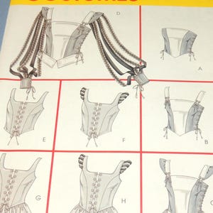 May include: A McCall's Costumes sewing pattern envelope, number 4107, featuring illustrations of various bodice and corset designs. The designs include options with lace-up fronts, side lacing, peplum hems, and long, flowing ribbon-style sleeves.
