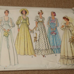 May include: Vintage Simplicity sewing pattern featuring illustrations of five different wedding dresses. The dresses have long sleeves, high necklines, and flowing skirts. The pattern envelope is white with blue and green text, including the number "390".