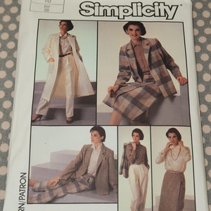May include: Simplicity sewing pattern number 7033 for a women's suit. The pattern includes four different looks: a white jacket with pants, a plaid jacket with skirt, a plaid jacket with pants, and a blouse with a skirt. The pattern is for sizes 10-38.